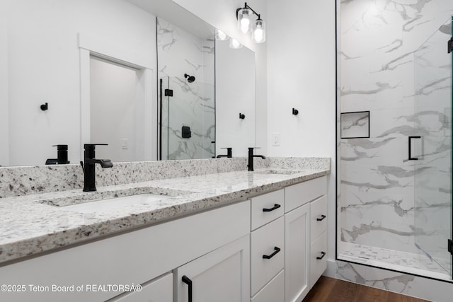 833 Booshway St, Driggs, ID 83422 - bathroom with double vanity, a marble finish shower, and wood finished floors