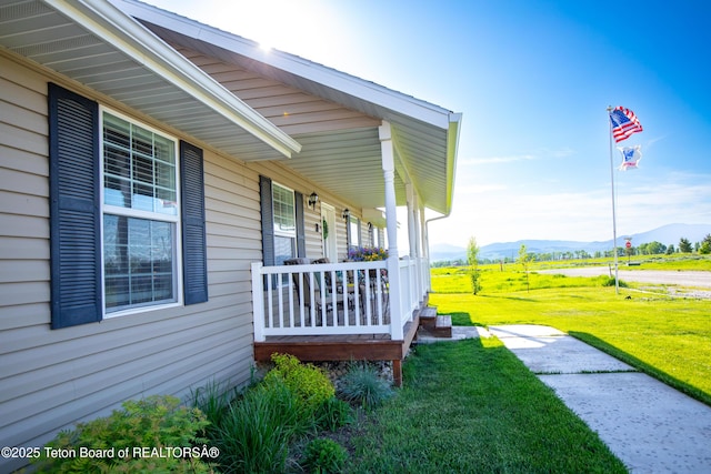 28 Brushwood Dr, Star Valley Ranch, WY 83127 - view of property exterior featuring a mountain view, a porch, and a yard