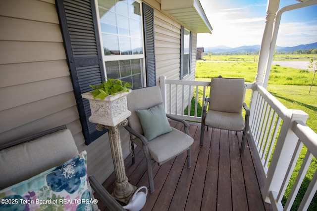28 Brushwood Dr, Star Valley Ranch, WY 83127 - wooden porch with a mountain view, a yard, and a rural view