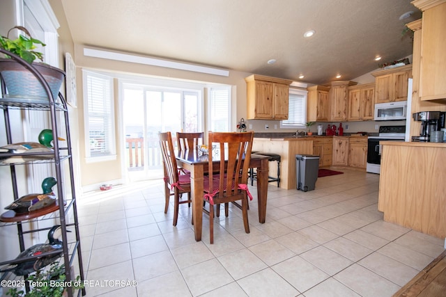 28 Brushwood Dr, Star Valley Ranch, WY 83127 - dining area with light tile patterned floors, lofted ceiling, and recessed lighting
