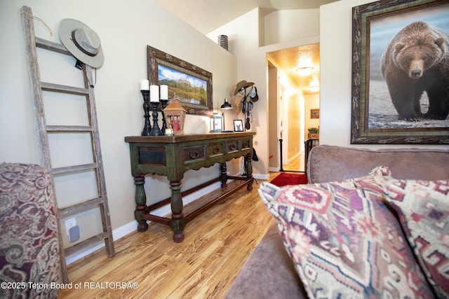28 Brushwood Dr, Star Valley Ranch, WY 83127 - living area featuring light wood-style flooring, vaulted ceiling, and baseboards