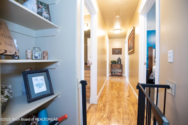 28 Brushwood Dr, Star Valley Ranch, WY 83127 - hall with light wood-style flooring and a textured ceiling
