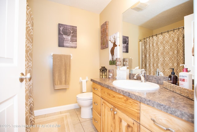 28 Brushwood Dr, Star Valley Ranch, WY 83127 - full bathroom featuring vanity, tile patterned flooring, toilet, baseboards, and a textured ceiling