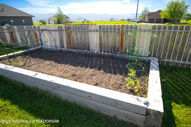 28 Brushwood Dr, Star Valley Ranch, WY 83127 - fenced backyard featuring a mountain view and a garden