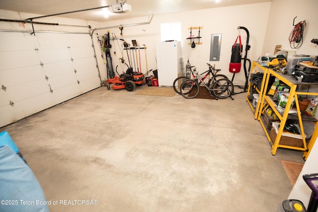 28 Brushwood Dr, Star Valley Ranch, WY 83127 - garage with electric panel, freestanding refrigerator, and a garage door opener