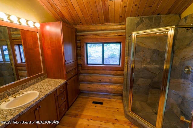 3392 Bainbridge Dr, Tetonia, ID 83452 - bathroom featuring vanity, hardwood / wood-style floors, a marble finish shower, wood ceiling, and log walls