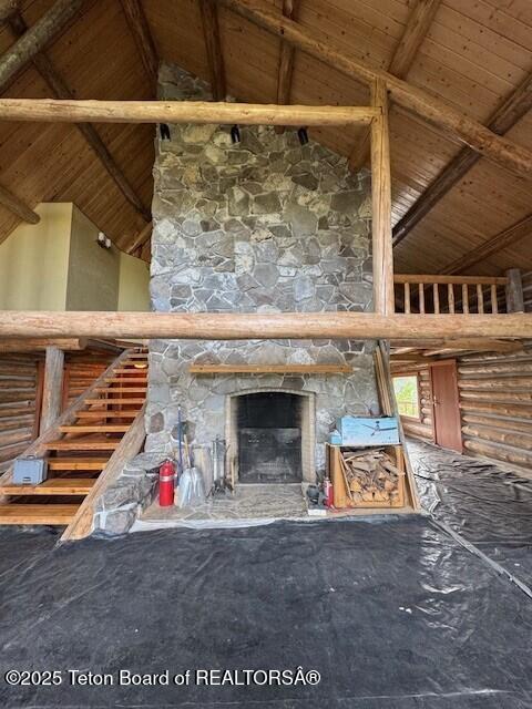 3392 Bainbridge Dr, Tetonia, ID 83452 - unfurnished living room featuring a wooden ceiling with exposed beams, a fireplace, and high vaulted ceiling