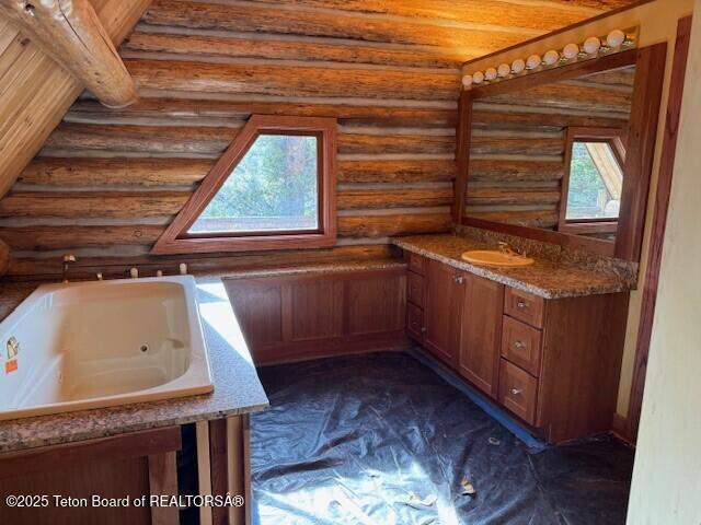 3392 Bainbridge Dr, Tetonia, ID 83452 - full bathroom with log walls, vanity, and a jetted tub