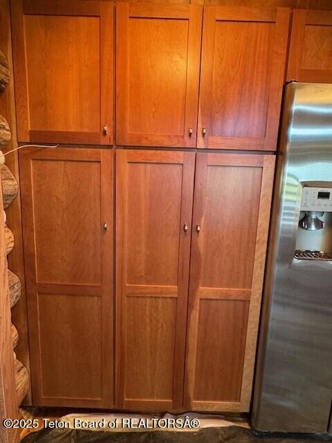 3392 Bainbridge Dr, Tetonia, ID 83452 - detailed view of stainless steel refrigerator with ice dispenser and brown cabinets