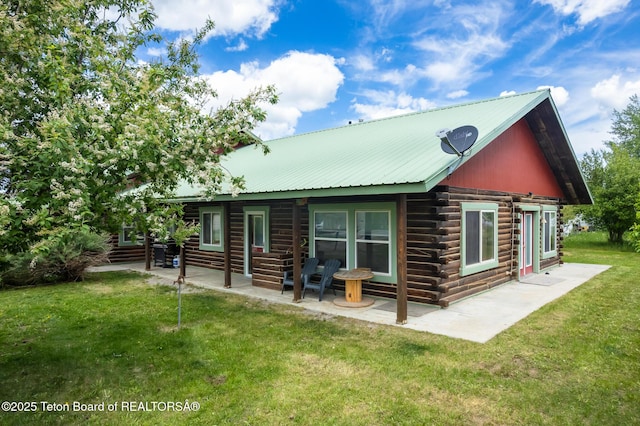 485 E Little Ave, Driggs, ID 83422 - back of property featuring a lawn, a patio area, log exterior, metal roof, and entry steps