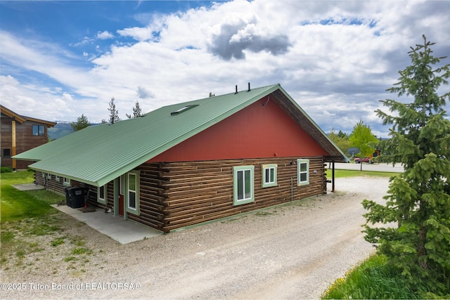 485 E Little Ave, Driggs, ID 83422 - view of home's exterior with log siding, dirt driveway, and metal roof