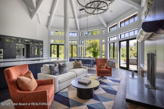 185 S Swan Rd, Jackson, WY 83001 - living area featuring a high ceiling, beam ceiling, and a chandelier