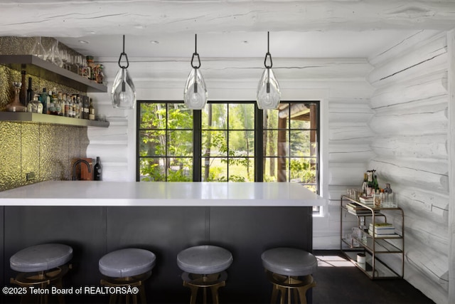 185 S Swan Rd, Jackson, WY 83001 - indoor bar featuring log walls and pendant lighting