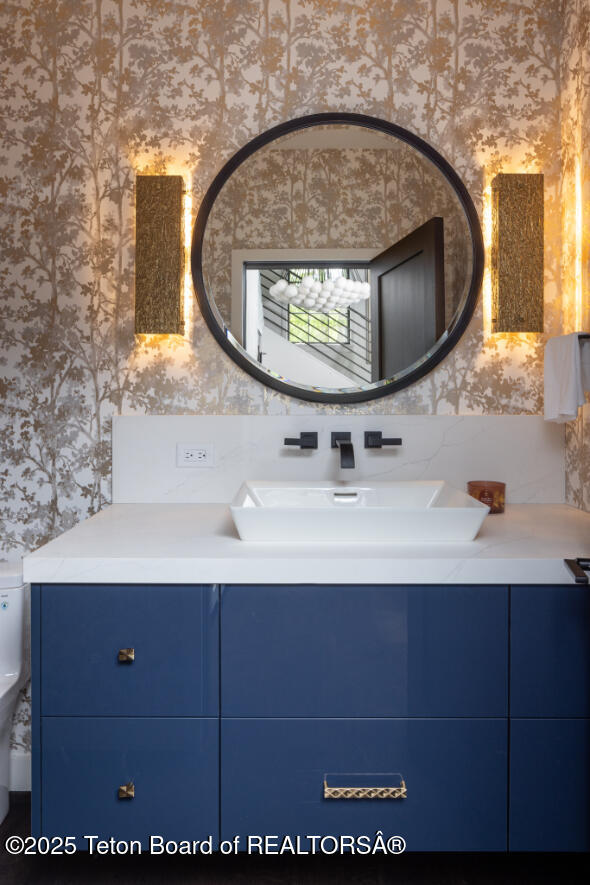 185 S Swan Rd, Jackson, WY 83001 - bathroom with wallpapered walls and vanity