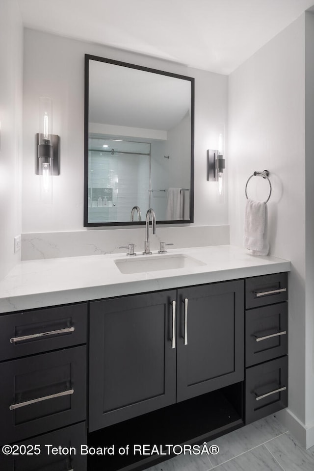 185 S Swan Rd, Jackson, WY 83001 - full bath with vanity, marble look tile flooring, and a shower