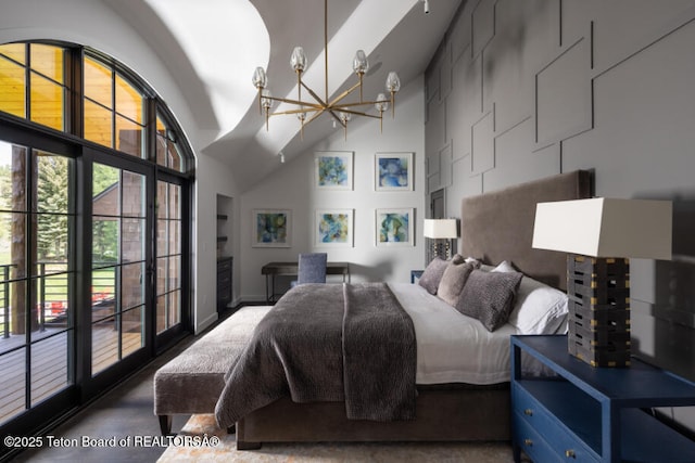 185 S Swan Rd, Jackson, WY 83001 - bedroom featuring a chandelier, a towering ceiling, access to exterior, and concrete flooring