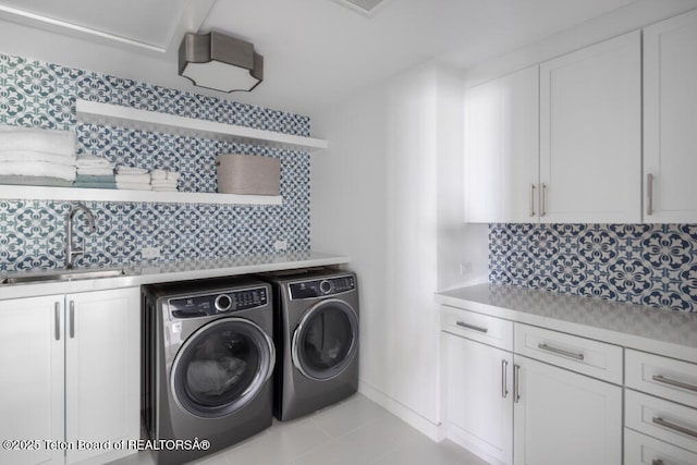 185 S Swan Rd, Jackson, WY 83001 - washroom with washer and clothes dryer, cabinet space, and tile patterned floors