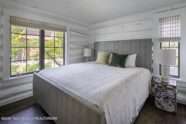 185 S Swan Rd, Jackson, WY 83001 - bedroom with multiple windows and dark wood-type flooring
