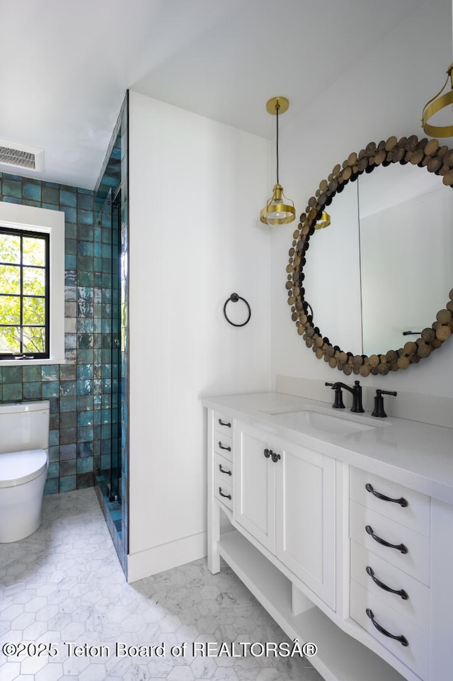 185 S Swan Rd, Jackson, WY 83001 - bathroom featuring vanity, marble look tile flooring, a stall shower, and tile walls