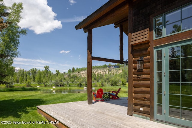 185 S Swan Rd, Jackson, WY 83001 - wooden terrace featuring a water view and a yard