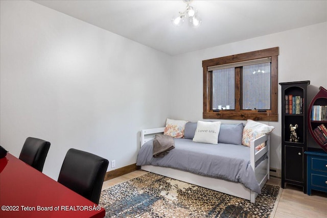 2130 Corner Creek Ln, Jackson, WY 83001 - bedroom featuring light wood-type flooring, a chandelier, and baseboards