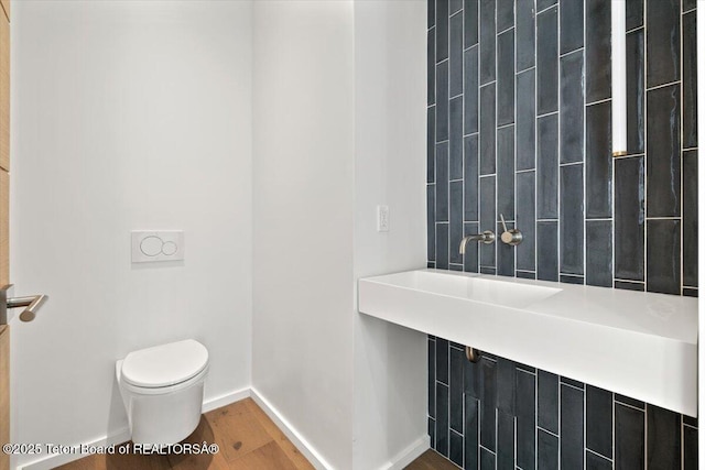 80 Rancher St, Jackson, WY 83001 - bathroom featuring toilet, wood finished floors, and baseboards