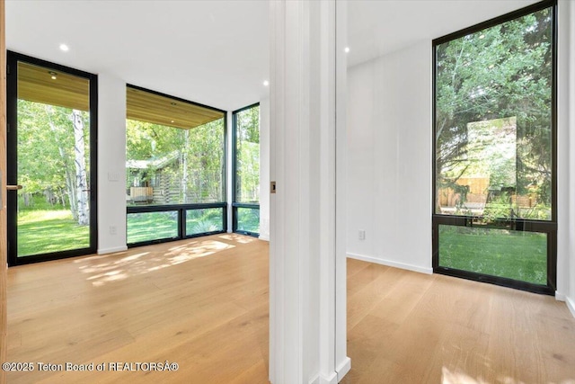 80 Rancher St, Jackson, WY 83001 - spare room featuring expansive windows, wood finished floors, and baseboards