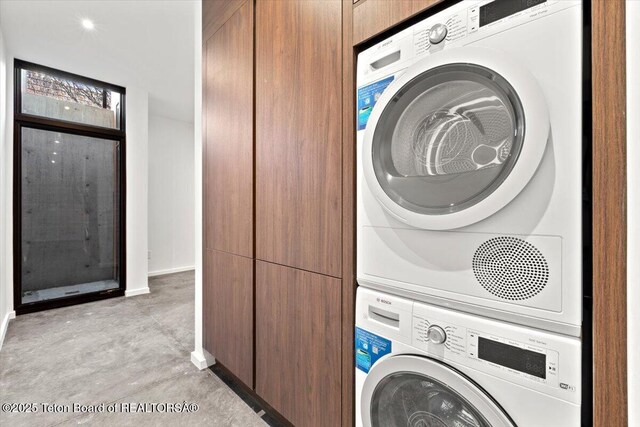 80 Rancher St, Jackson, WY 83001 - laundry room with stacked washer and clothes dryer and baseboards