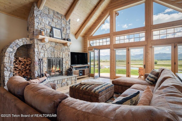2321 S 3500 W, Driggs, ID 83422 - living area featuring a wood ceiling with exposed beams, high vaulted ceiling, and a stone fireplace