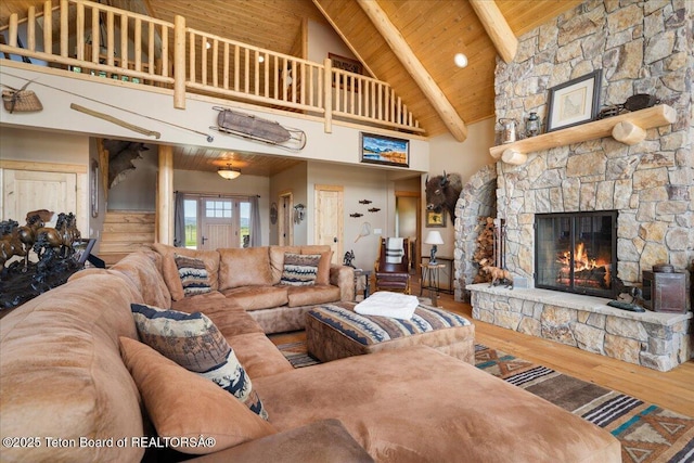 2321 S 3500 W, Driggs, ID 83422 - living area featuring high vaulted ceiling, a stone fireplace, wood finished floors, and a wooden ceiling with exposed beams