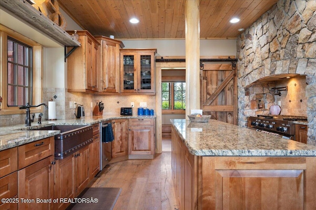 2321 S 3500 W, Driggs, ID 83422 - kitchen featuring wood ceiling, stove, light wood-style flooring, brown cabinets, and light stone counters