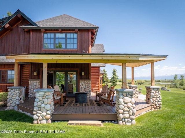 2321 S 3500 W, Driggs, ID 83422 - back of property featuring a shingled roof, a lawn, and stone siding