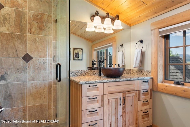 2321 S 3500 W, Driggs, ID 83422 - bathroom featuring wood ceiling, vaulted ceiling, vanity, a stall shower, and plenty of natural light