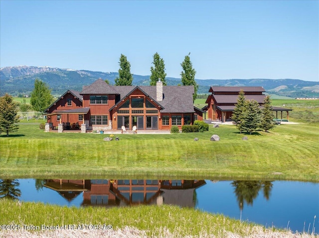 2321 S 3500 W, Driggs, ID 83422 - rear view of property featuring a water and mountain view, board and batten siding, a chimney, and a lawn