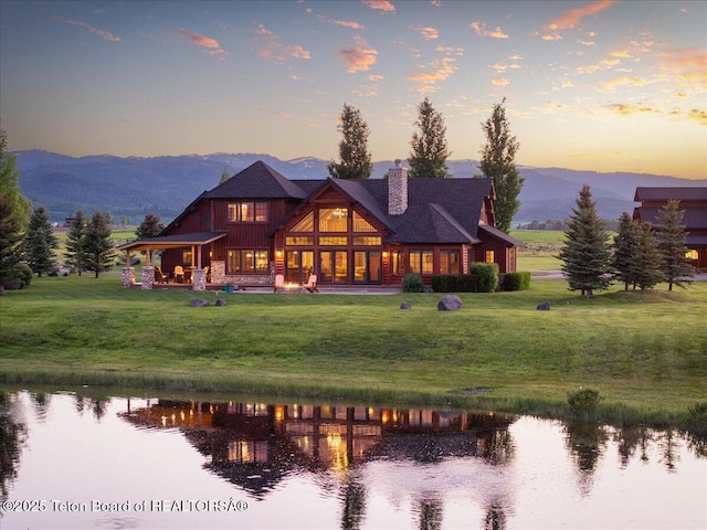 2321 S 3500 W, Driggs, ID 83422 - rear view of house with a chimney, a water view, and a lawn