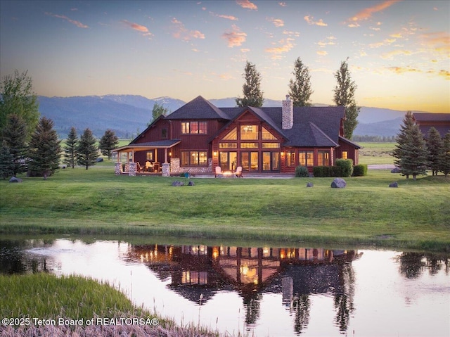 2321 S 3500 W, Driggs, ID 83422 - back of house featuring a chimney, a water and mountain view, and a lawn
