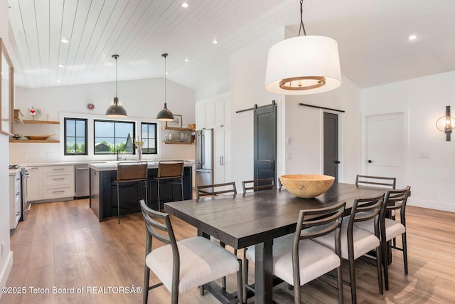 4326 State Line Rd, Freedom, WY 83120 - dining area featuring light wood-type flooring, a barn door, recessed lighting, high vaulted ceiling, and wood ceiling
