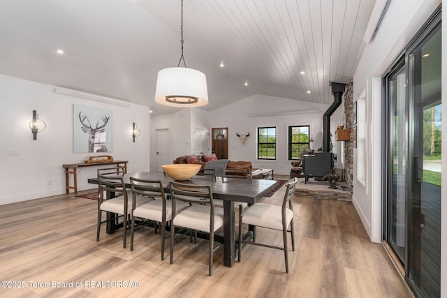 4326 State Line Rd, Freedom, WY 83120 - dining space with a wood stove, light wood finished floors, lofted ceiling, recessed lighting, and wood ceiling