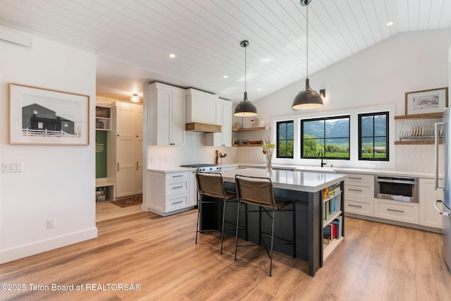 4326 State Line Rd, Freedom, WY 83120 - kitchen with open shelves, light countertops, recessed lighting, vaulted ceiling, and white cabinetry