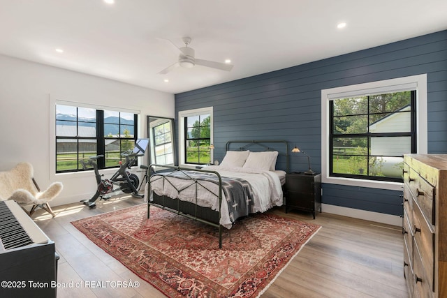 4326 State Line Rd, Freedom, WY 83120 - bedroom with light wood-type flooring, recessed lighting, ceiling fan, and wooden walls