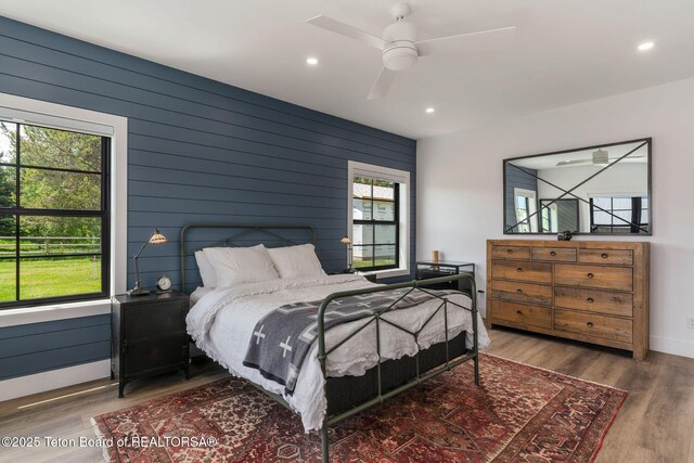 4326 State Line Rd, Freedom, WY 83120 - bedroom with multiple windows, recessed lighting, wood finished floors, wood walls, and ceiling fan
