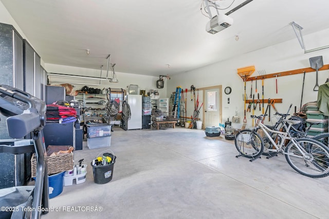 4326 State Line Rd, Freedom, WY 83120 - garage with freestanding refrigerator and a garage door opener