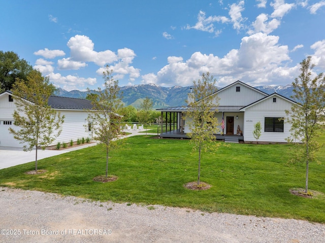 4326 State Line Rd, Freedom, WY 83120 - view of front facade with a metal roof, a standing seam roof, a front yard, a mountain view, and a porch
