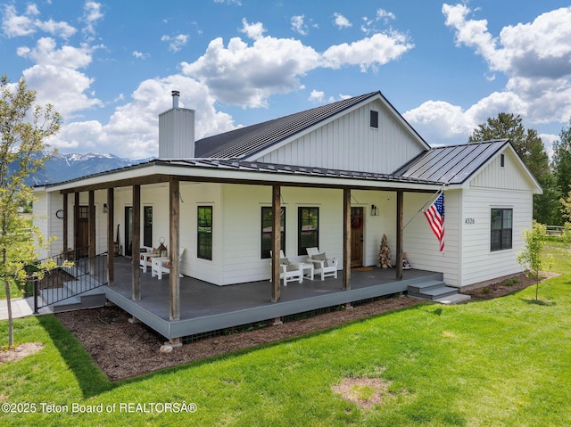 4326 State Line Rd, Freedom, WY 83120 - rear view of property with a standing seam roof, a yard, a porch, a metal roof, and a chimney