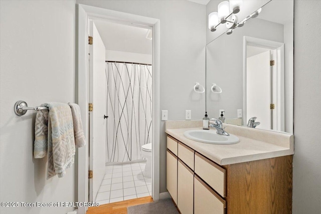 2176 Corner Creek Ln Unit C, Jackson, WY 83001 - full bath with vanity, toilet, a chandelier, tile patterned floors, and a shower with shower curtain