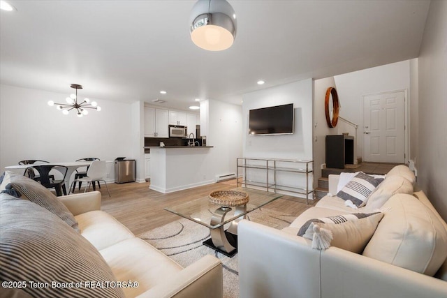514 E Pearl Ave, Jackson, WY 83001 - living room featuring baseboard heating, a chandelier, light wood finished floors, recessed lighting, and baseboards