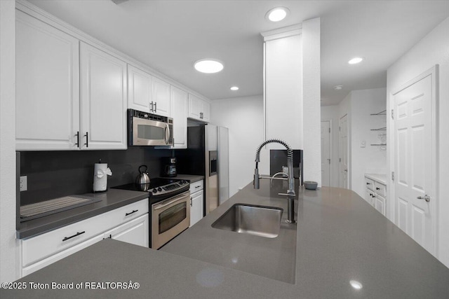 514 E Pearl Ave, Jackson, WY 83001 - kitchen featuring stainless steel appliances, a sink, dark countertops, white cabinets, and recessed lighting