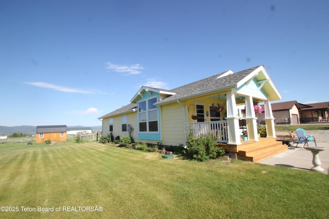 89 W W St, Star Valley Ranch, WY 83127 - back of property featuring a porch, a yard, and roof with shingles