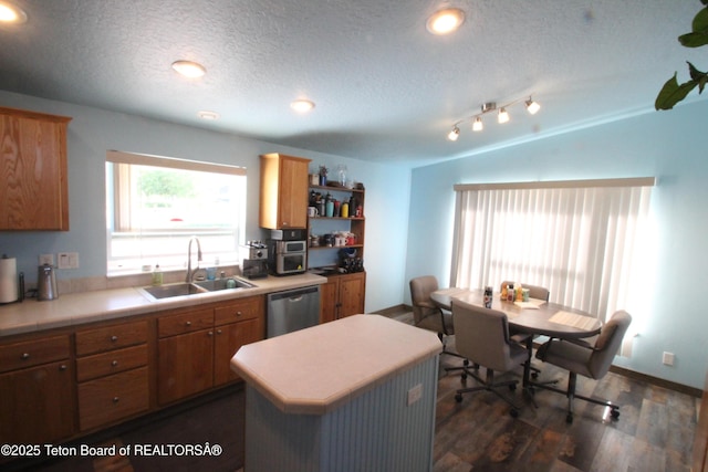 89 W W St, Star Valley Ranch, WY 83127 - kitchen with a sink, dishwasher, dark wood-type flooring, light countertops, and a textured ceiling