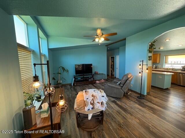 89 W W St, Star Valley Ranch, WY 83127 - living area featuring arched walkways, wood finished floors, ceiling fan, and a textured ceiling